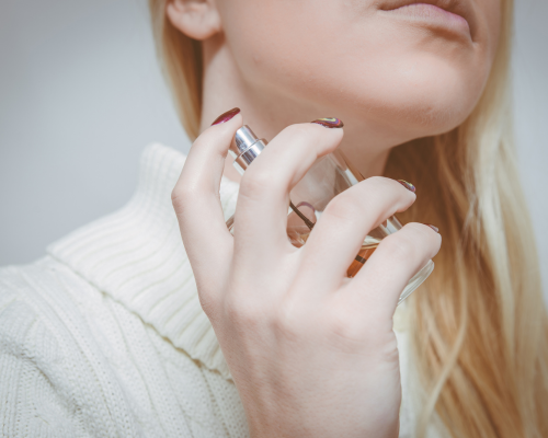 Woman applying perfume